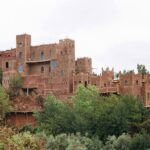 A traditional Berber village nestled in the High Atlas Mountains of Morocco, with stone houses and terraced landscapes