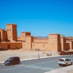 Traditional Moroccan kasbah with high earthen walls and towers, showcasing Berber architecture against a desert landscape